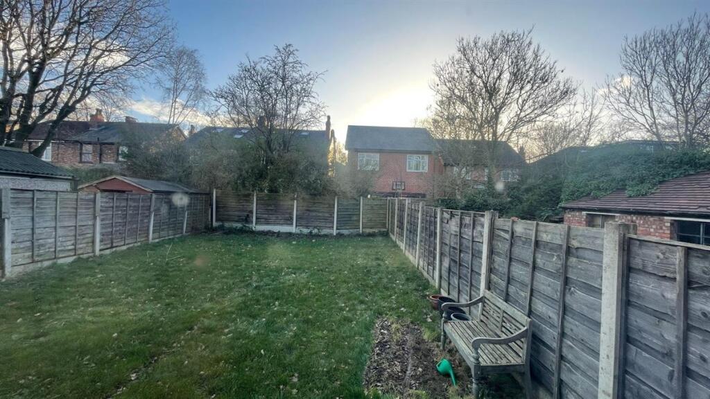 Private rear garden with a well-kept lawn, fenc...