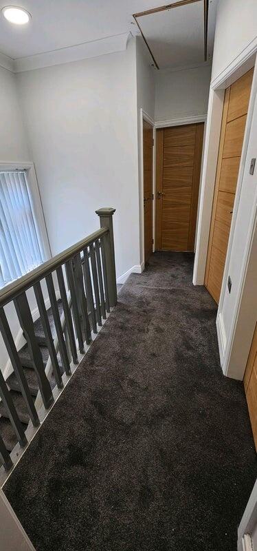 Bright first-floor landing with carpeted floors...