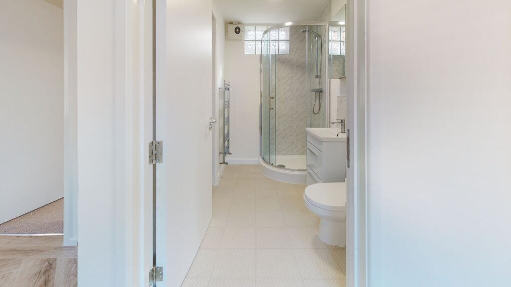 Bright and clean bathroom with a modern shower ...