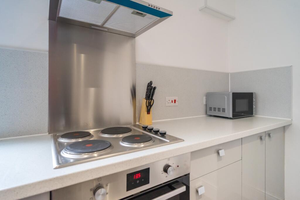 Modern kitchen featuring sleek countertops and ...