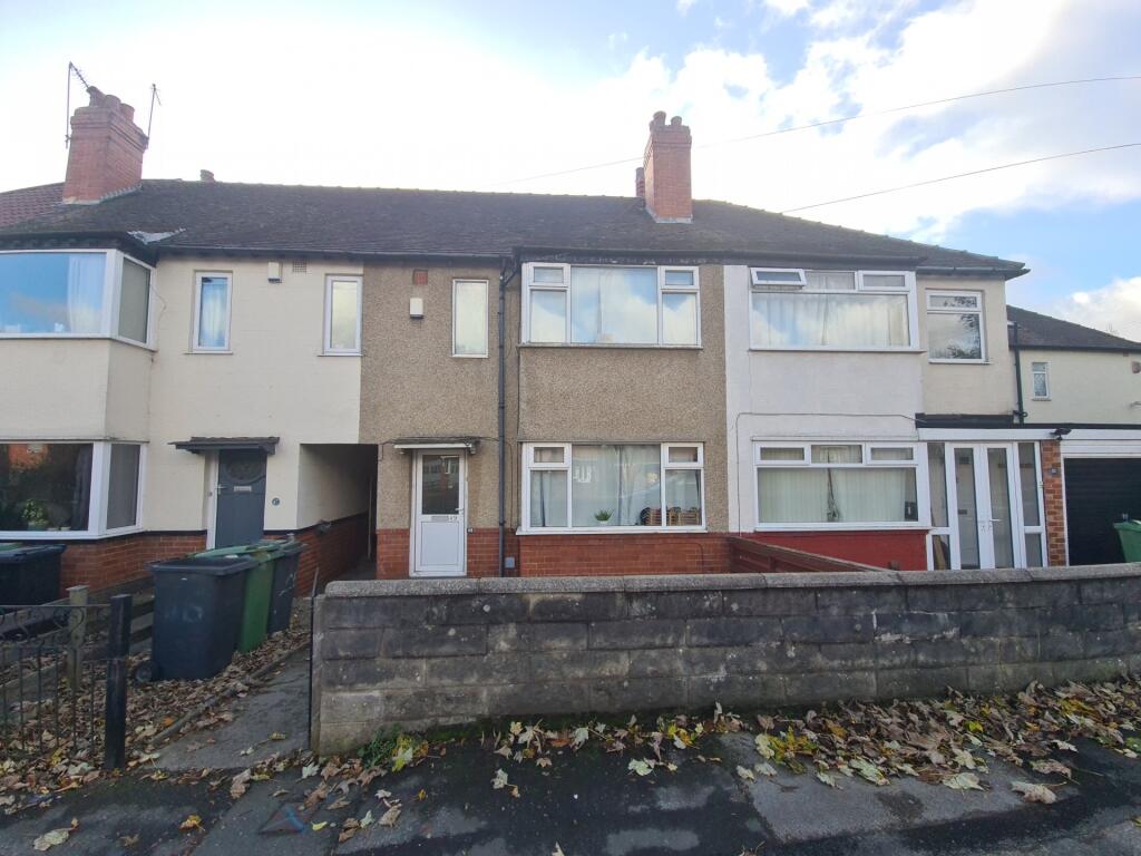 A charming terraced house with a neat front gar...
