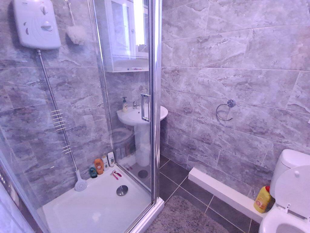 Modern bathroom with a sleek corner shower unit...