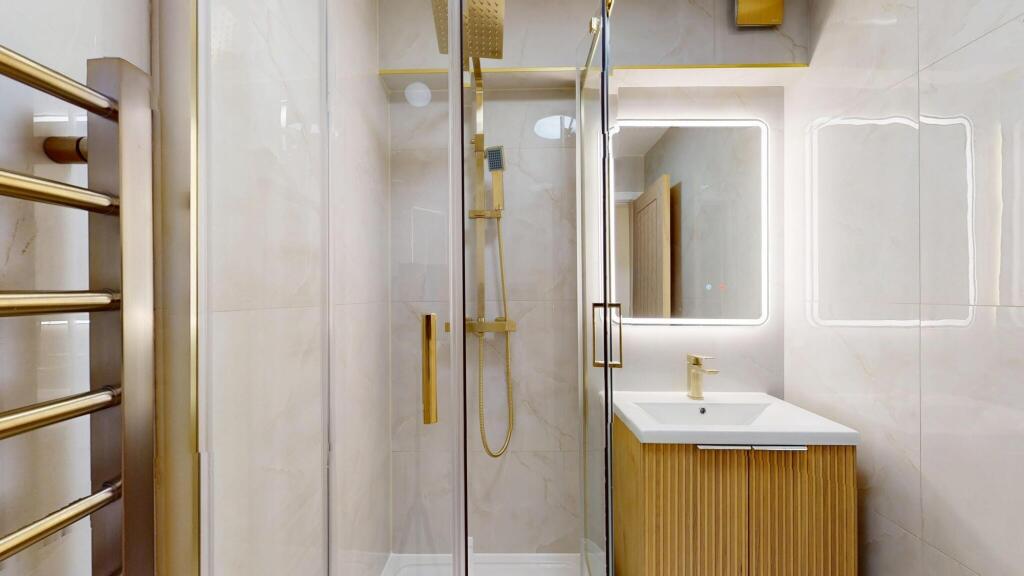 Modern bathroom featuring a sleek glass shower ...