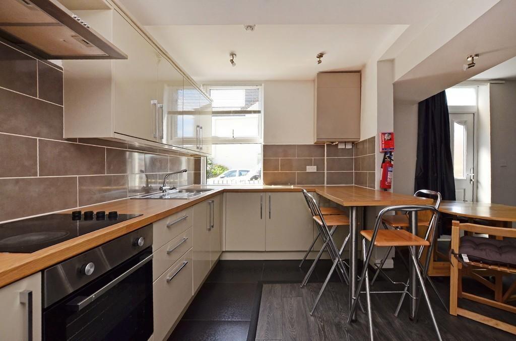 Bright and modern kitchen featuring ample count...