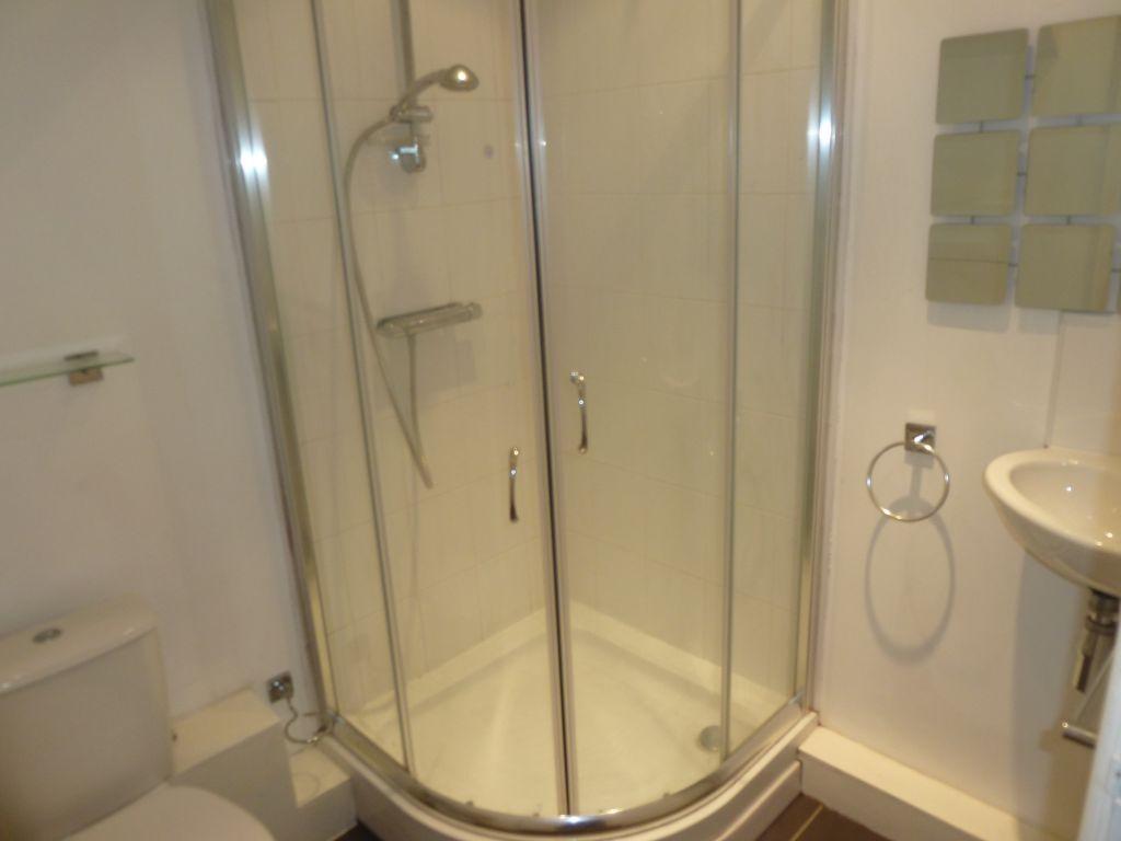 A clean and modern bathroom featuring a curved ...
