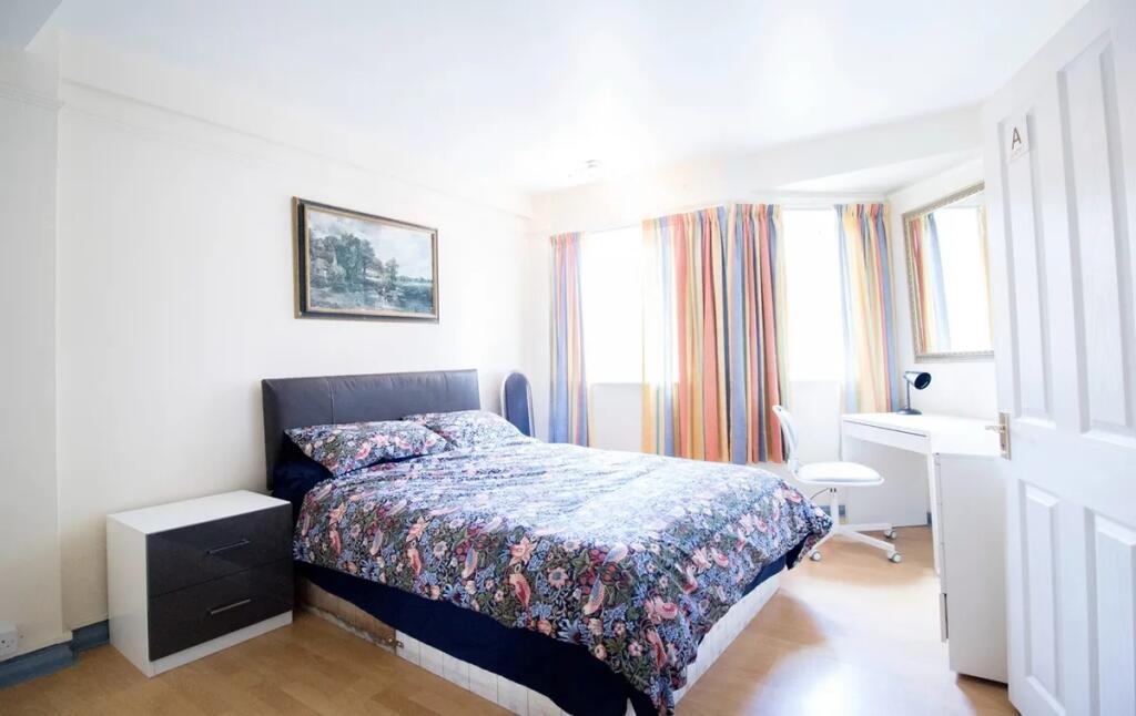 Bright and spacious master bedroom featuring a ...