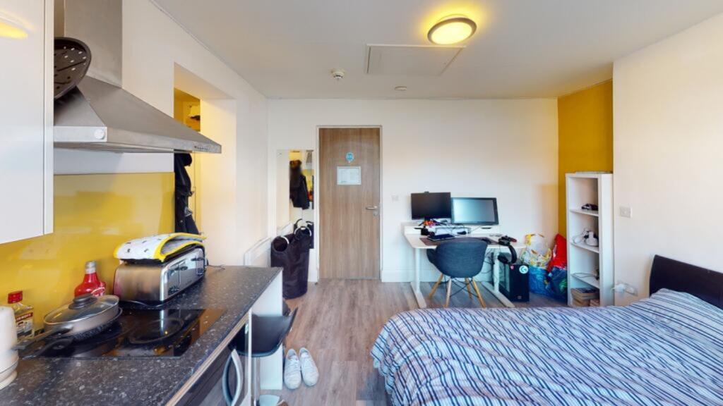 This inviting double bedroom features a cozy at...