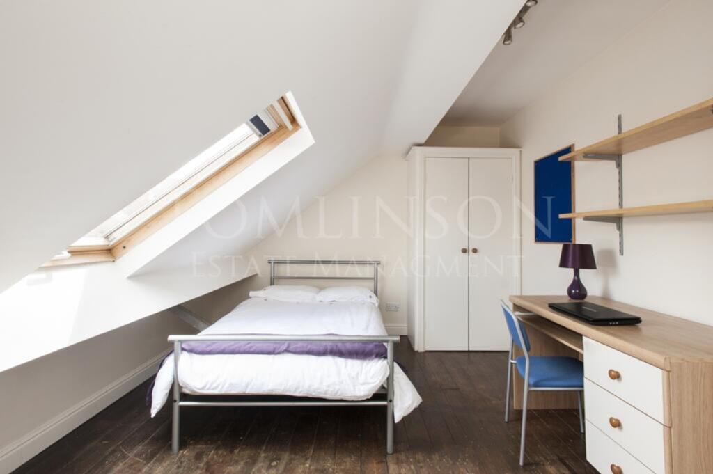 A bright and inviting double bedroom with a com...
