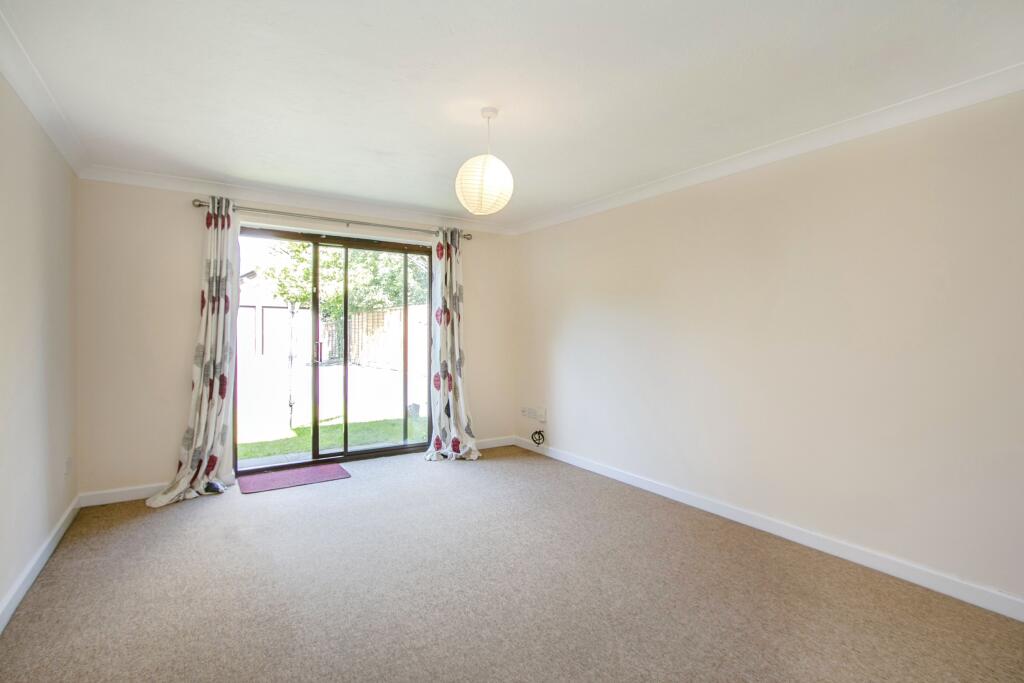 Lounge with patio doors leading to a small patio area