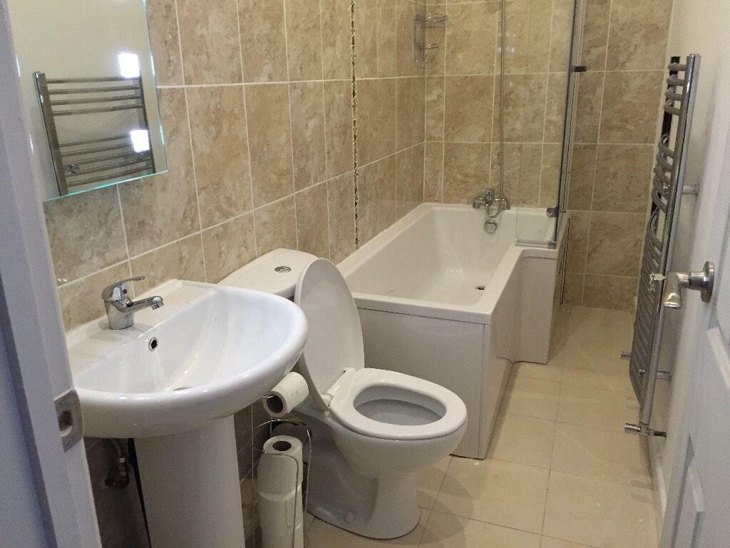 A modern bathroom suite featuring a clean white...