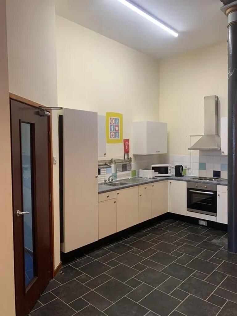 A spacious and well-lit kitchenette equipped wi...