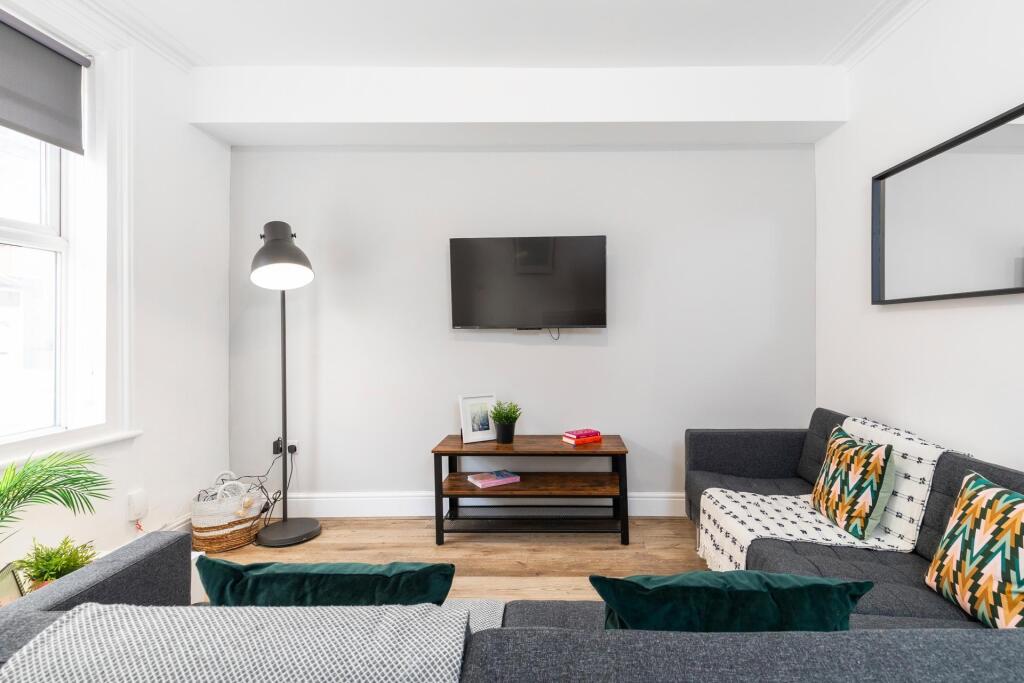 Bright, modern living room with comfortable sea...