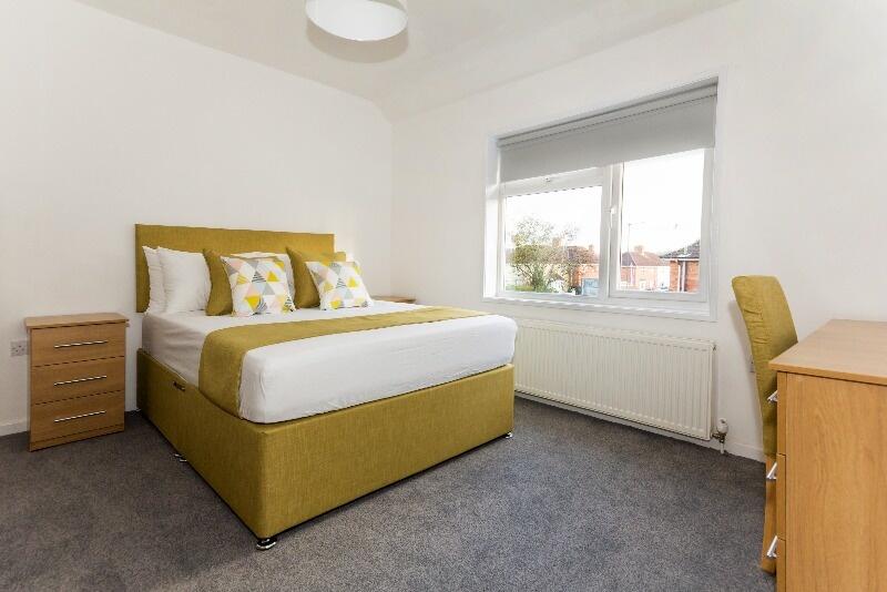 Bright and welcoming master bedroom featuring a...