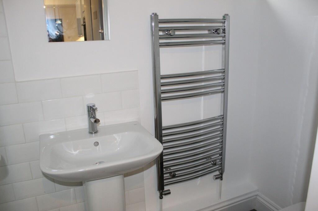 A clean and modern single toilet featuring a sl...