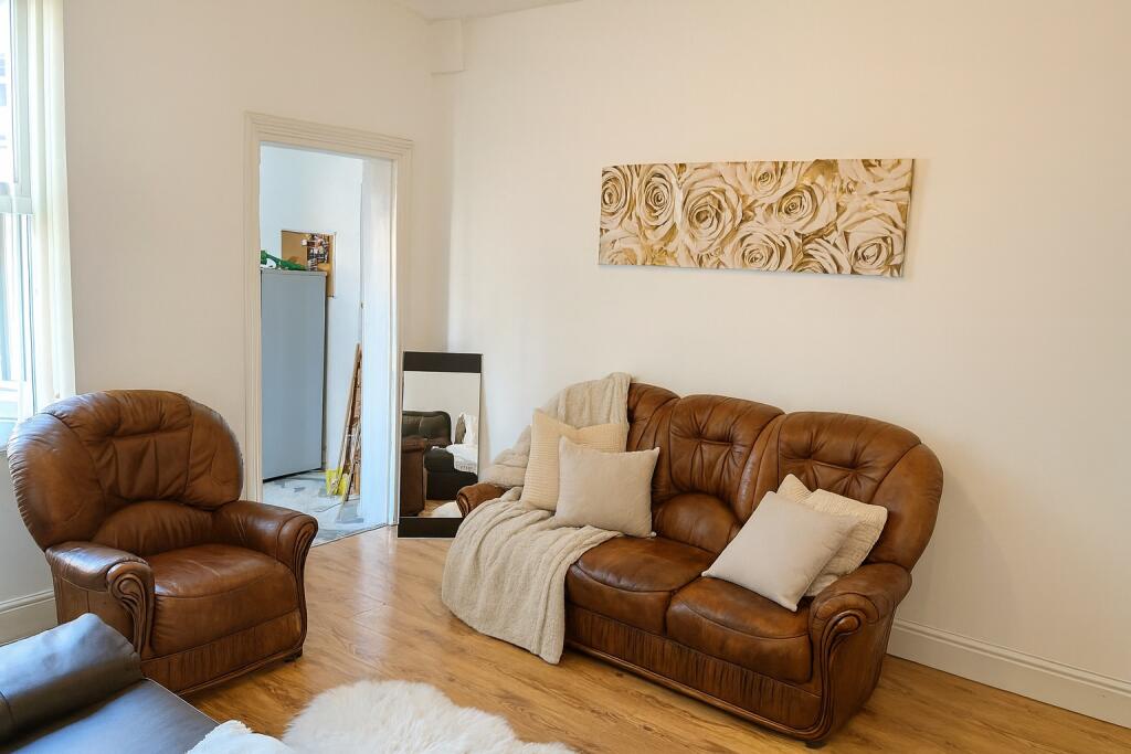Bright, welcoming living room with warm leather...