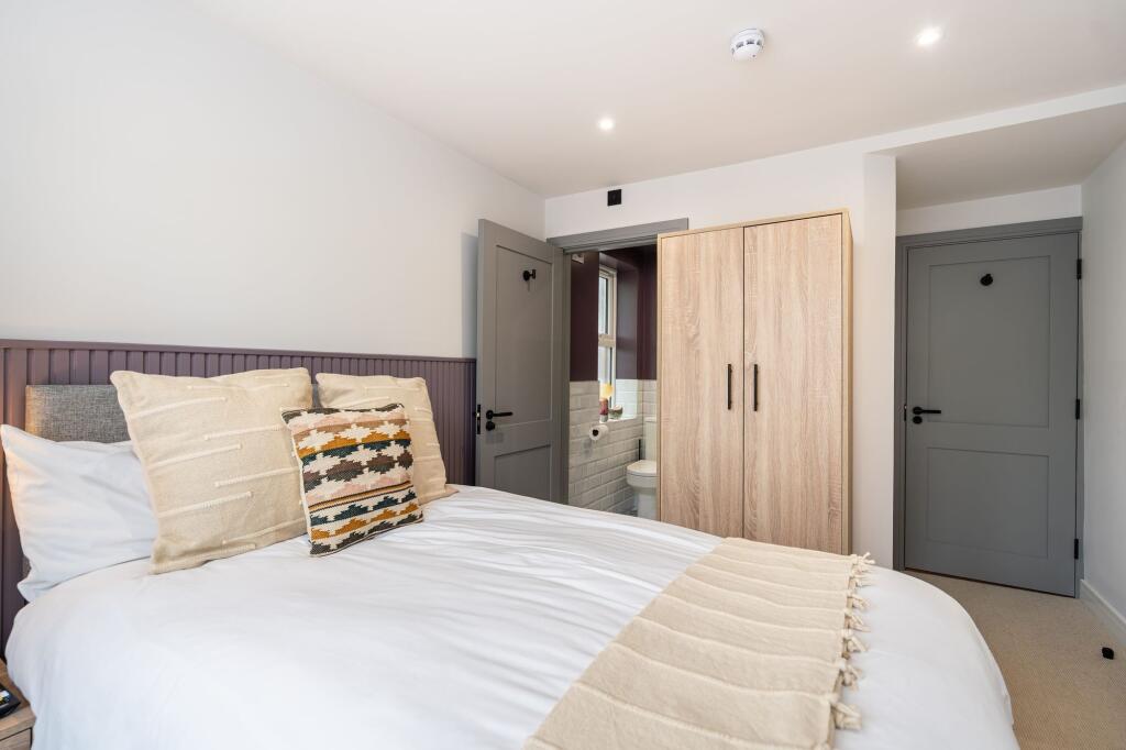 Bright and inviting master bedroom with a cozy ...