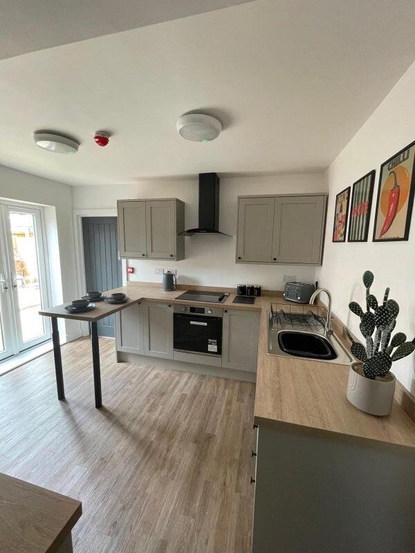 Bright, modern kitchen with ample countertop sp...