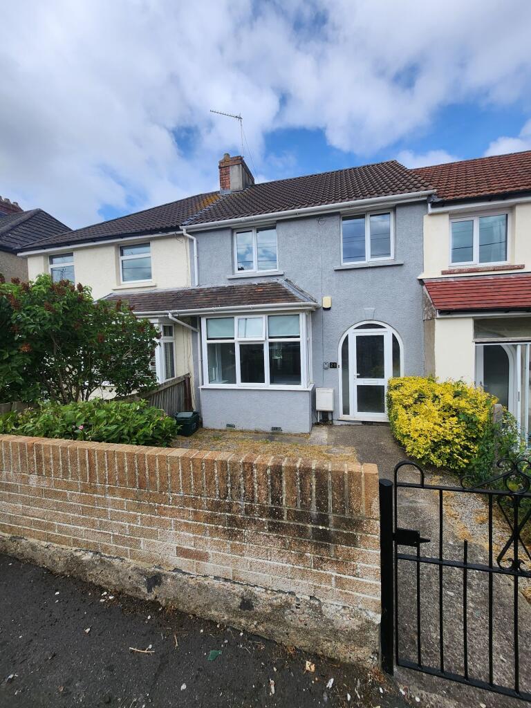 A charming terraced house with a neat front yar...