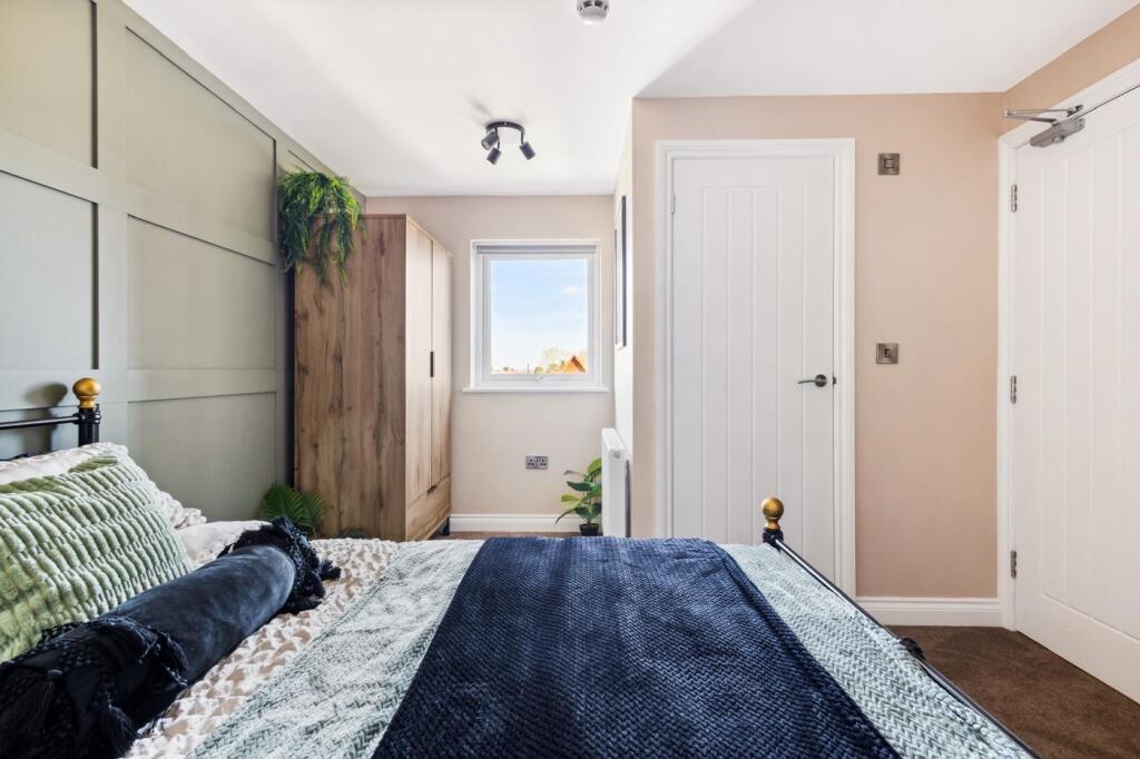 A beautifully designed double bedroom featuring...