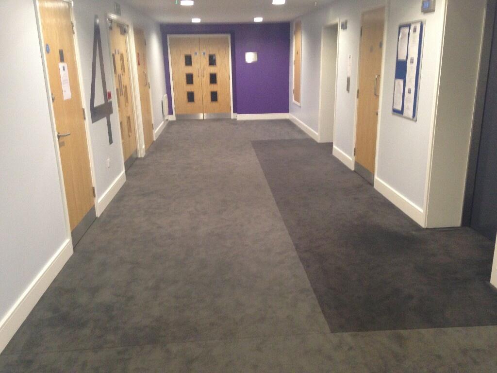 A spacious, well-maintained hallway in a studen...