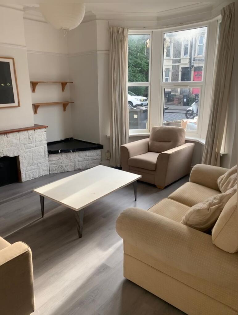 A bright and inviting living room with ample na...