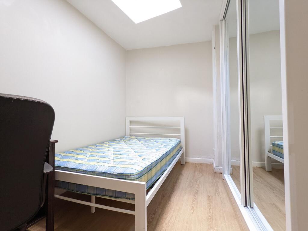 Bright, simply furnished single bedroom with a ...