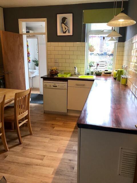 Bright and tidy kitchen with a large wooden cou...