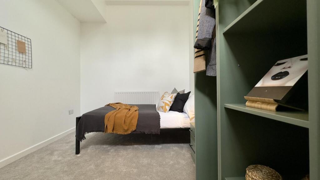 A cozy and inviting double bedroom featuring st...