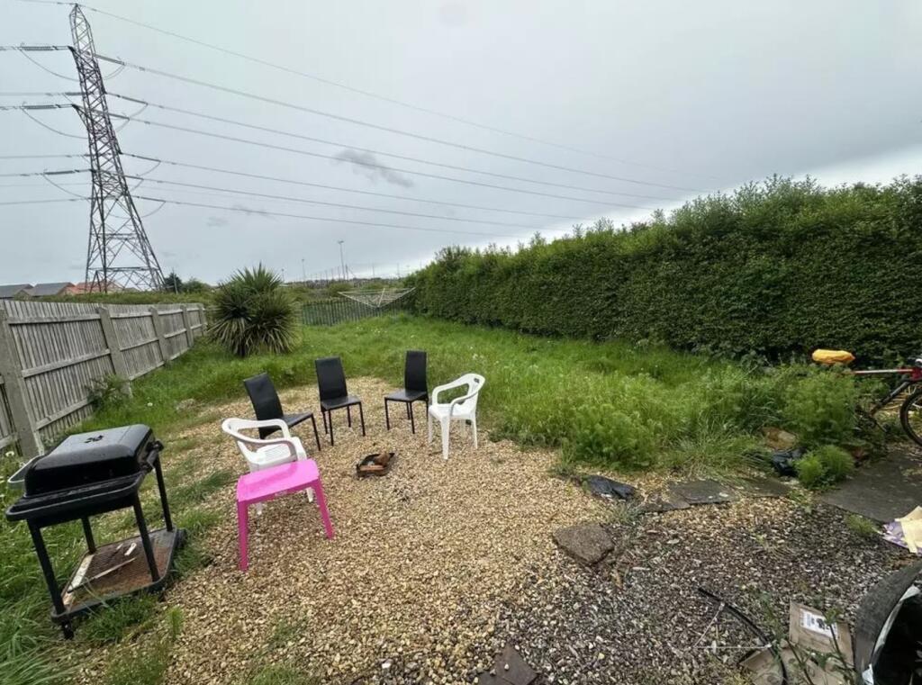 A spacious garden area with seating, perfect fo...