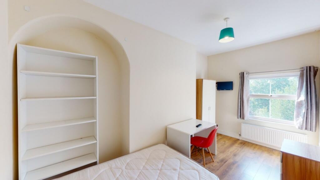 A bright and spacious double bedroom featuring ...