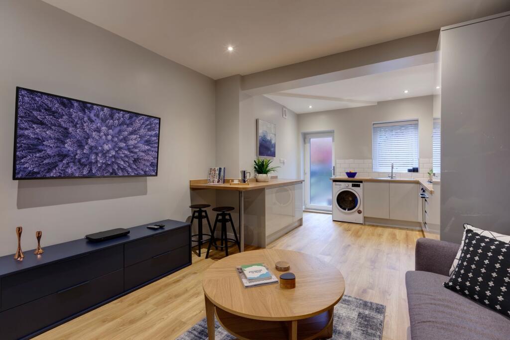 Bright and welcoming living room featuring mode...