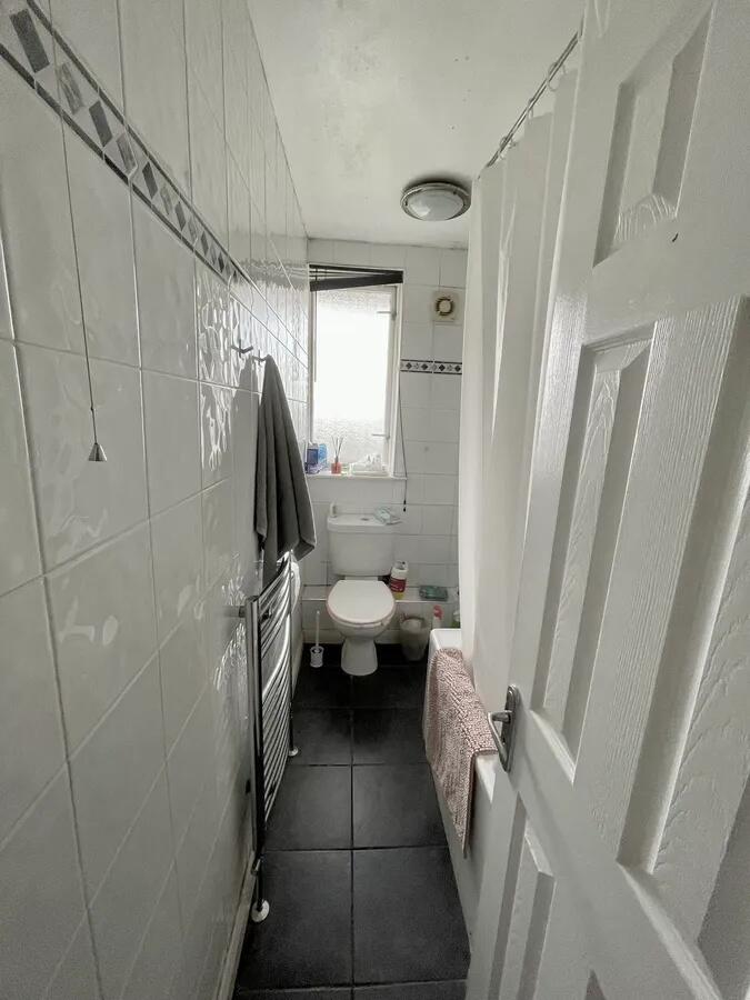 A clean and functional bathroom featuring white...