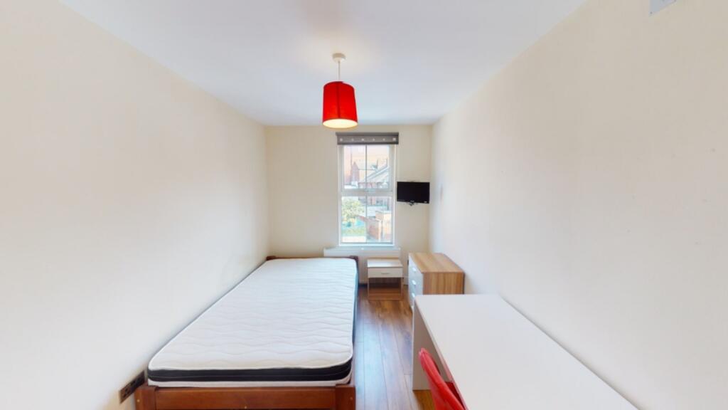 A well-lit single bedroom with a modern design,...