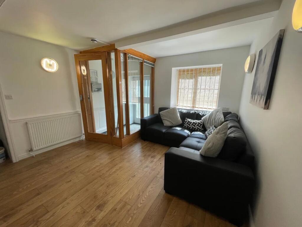 A neat and inviting living room featuring a sty...
