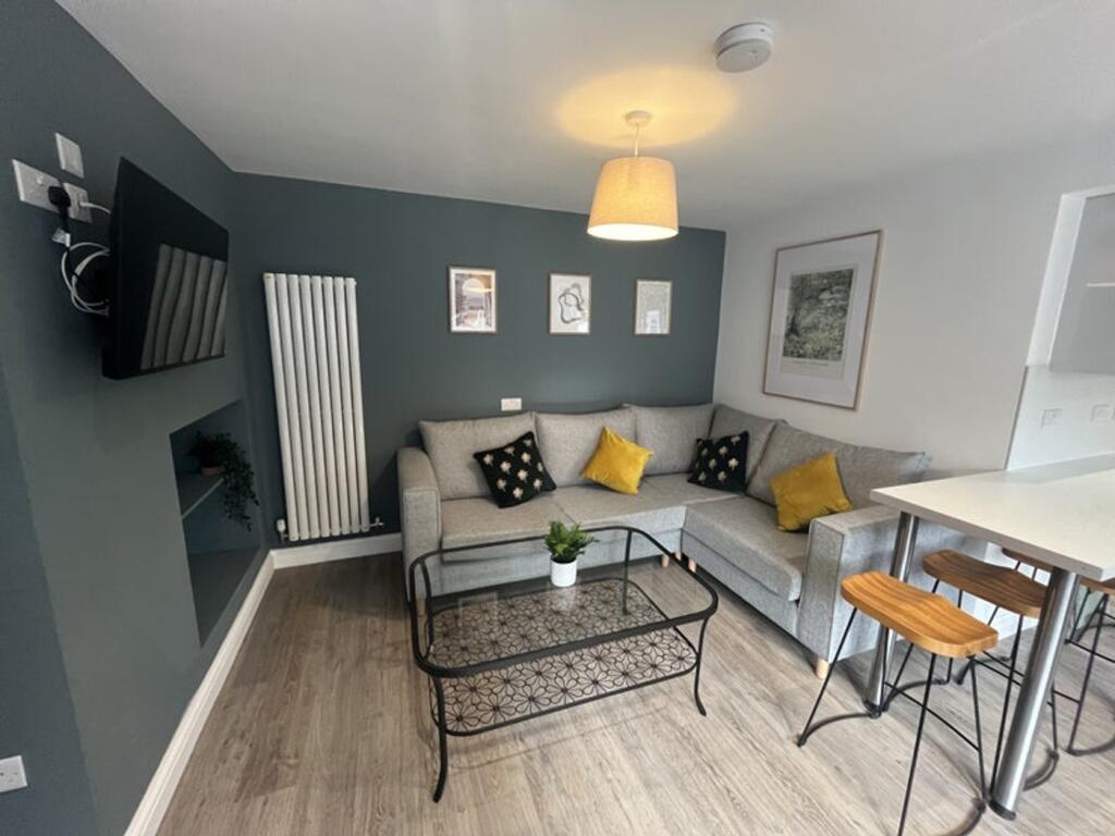 Stylish living room featuring a comfortable gre...