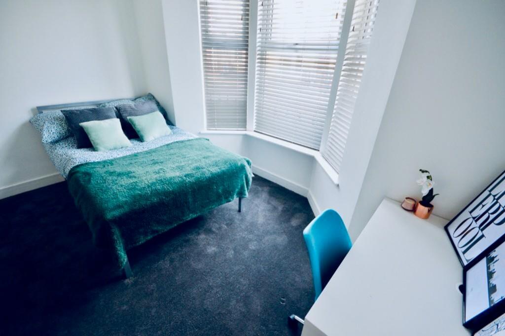 A bright and inviting double bedroom featuring ...