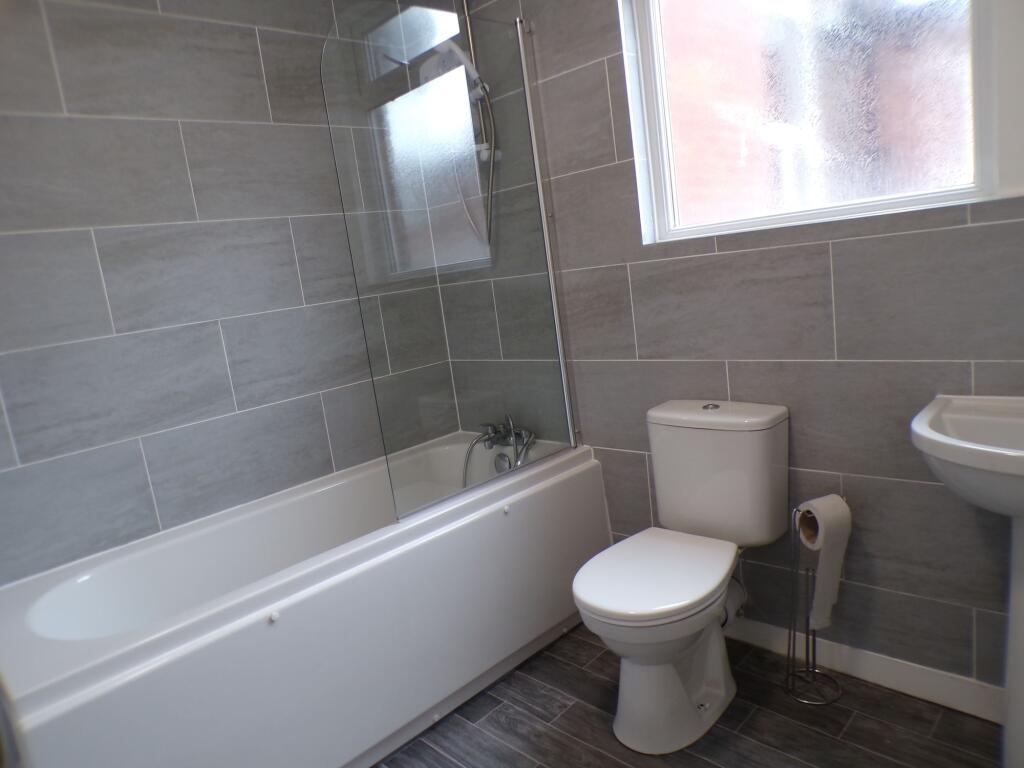 Modern and clean bathroom featuring a bathtub w...