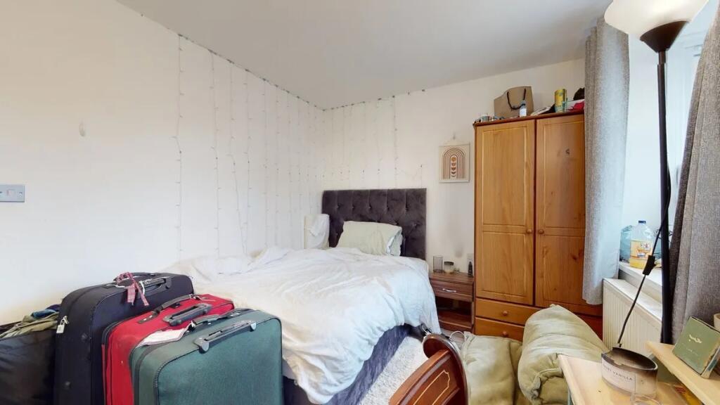 A cozy double bedroom featuring a plush dark he...