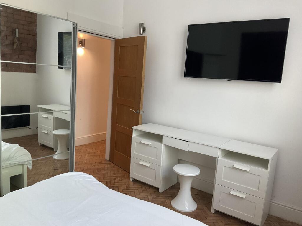 Bright and tidy double bedroom featuring a larg...