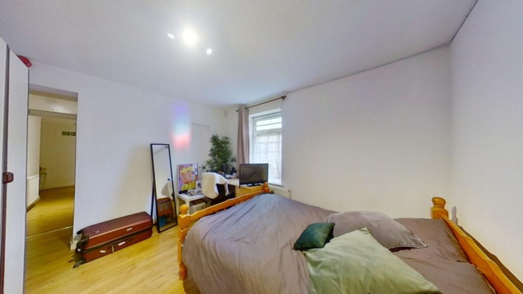 A spacious and inviting double bedroom with goo...
