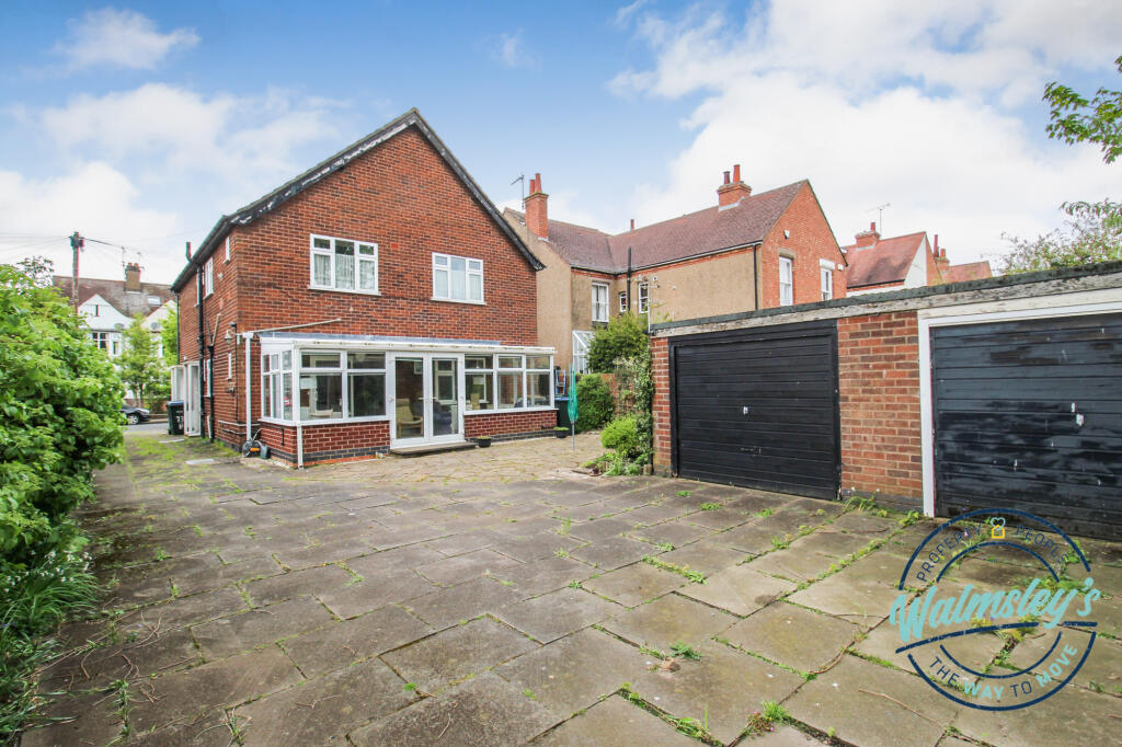 Rear elevation showing conservatory &amp; garage