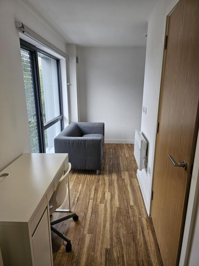 Bright and neat living room featuring a comfort...