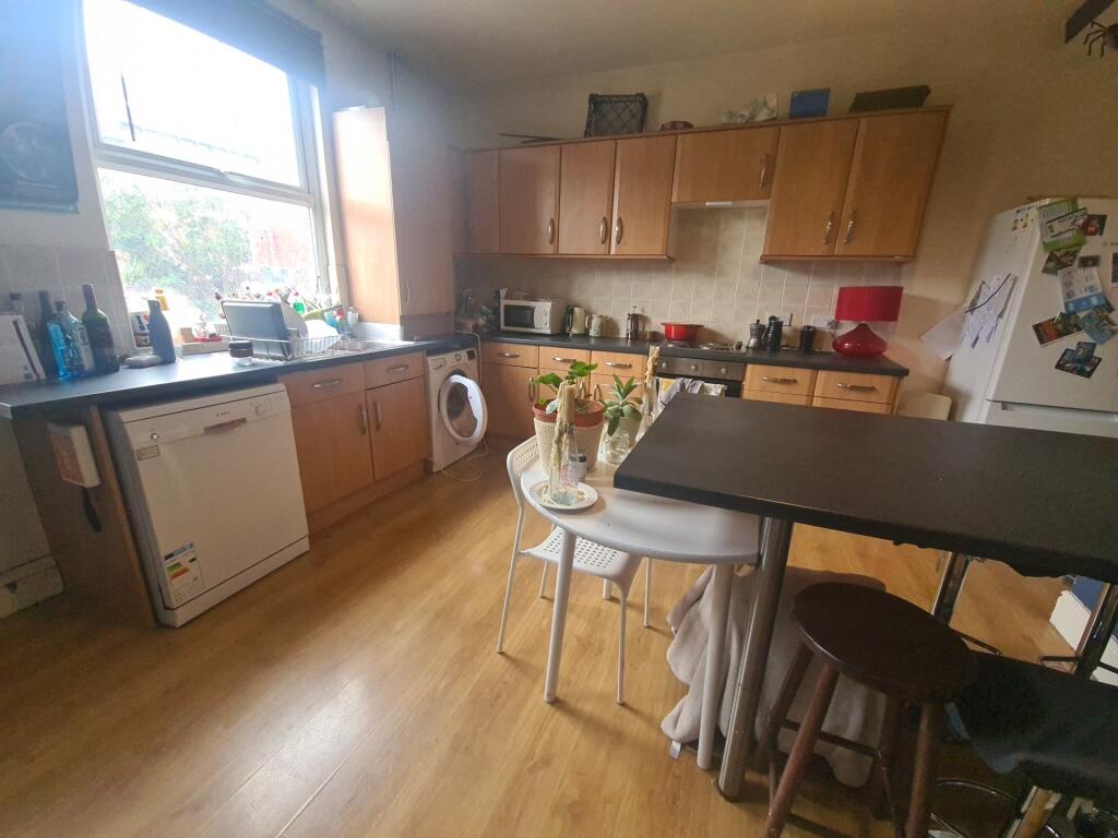 Bright and welcoming kitchen with ample natural...