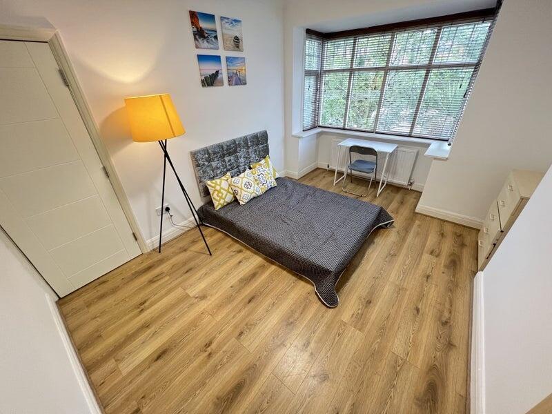 A bright and inviting double bedroom featuring ...