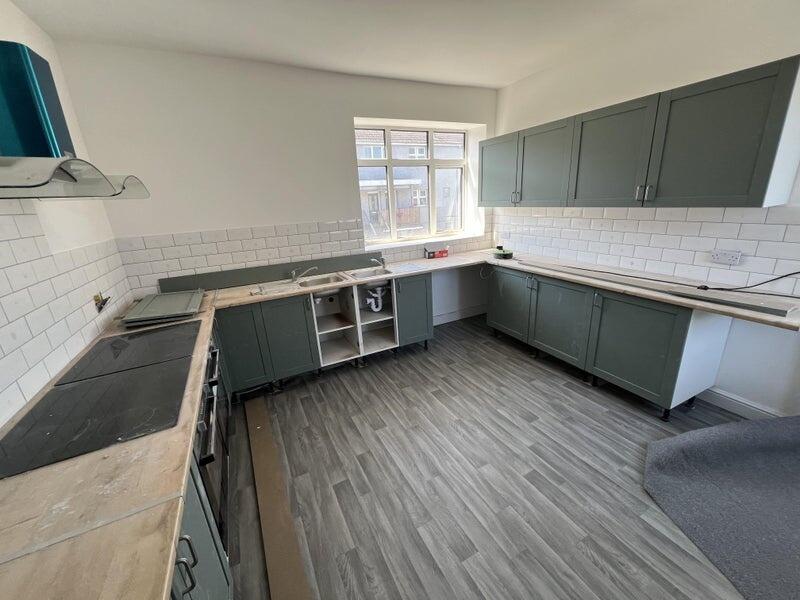 Bright and spacious kitchen featuring modern ca...