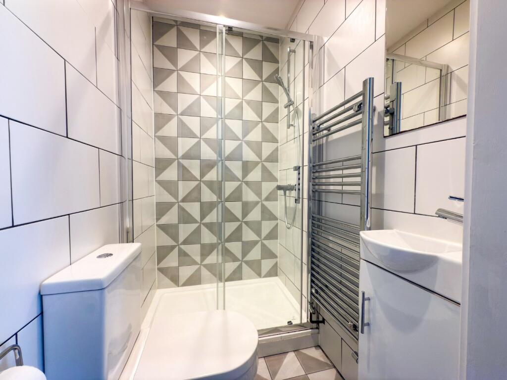 Bright, modern bathroom with a contemporary til...