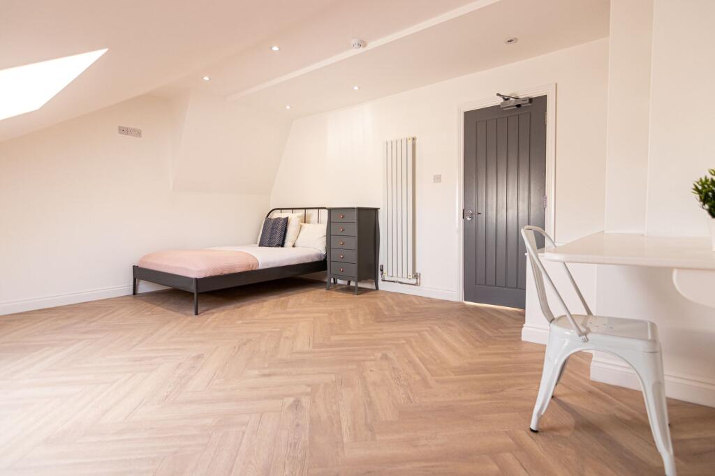 Bright and spacious bedroom with a stylish blac...