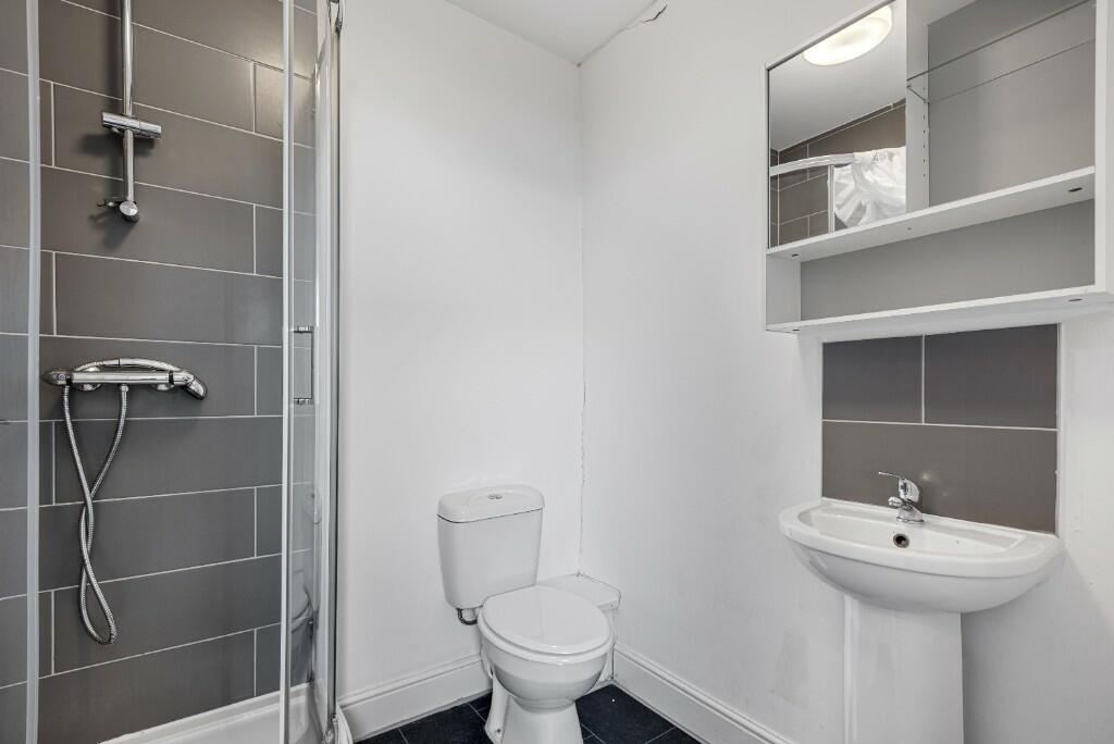 A modern and clean bathroom featuring a walk-in...