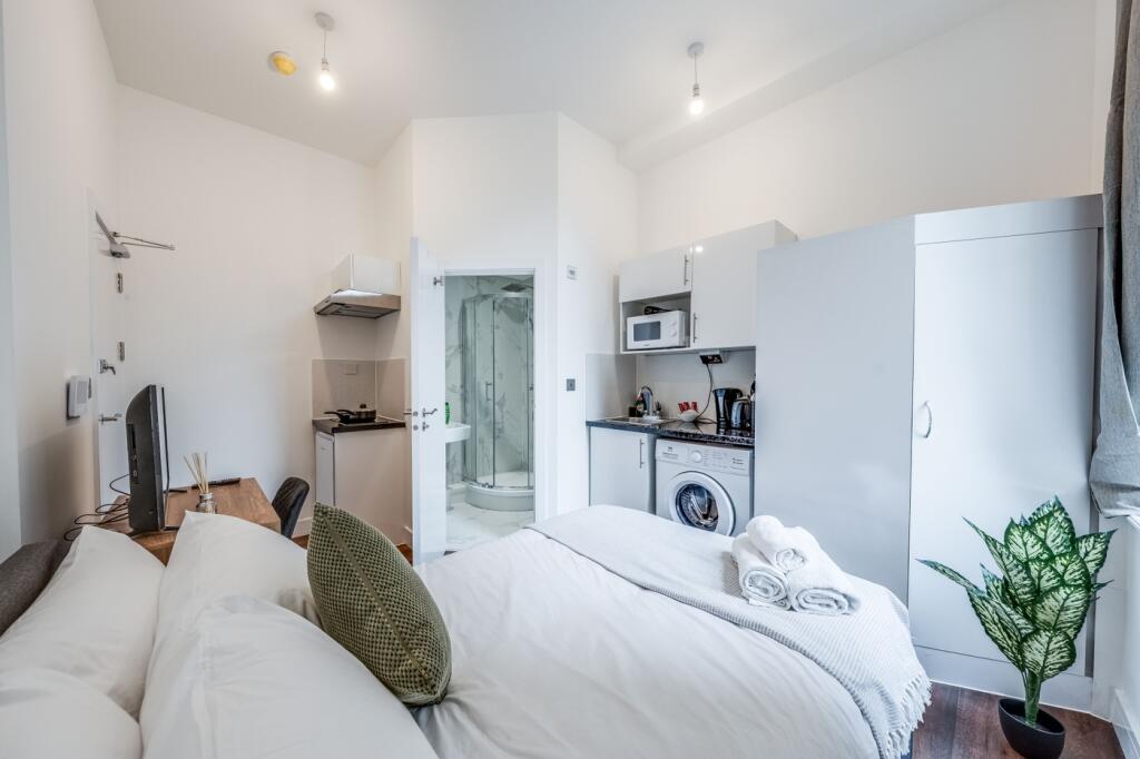 This inviting double bedroom features a cozy la...
