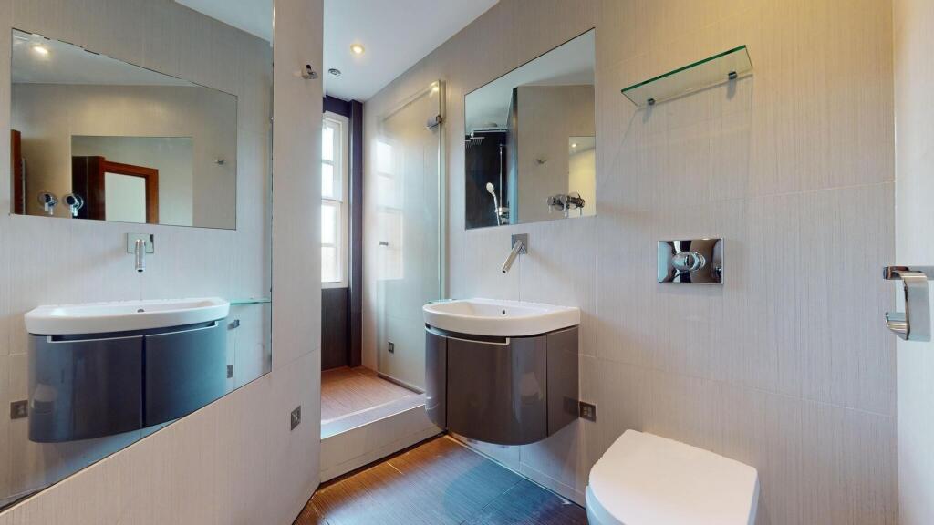 A modern bathroom featuring sleek fixtures, a f...